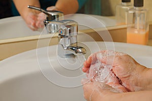 Closeup view of a woman washing her hands with soap