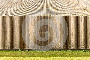 Closeup view of wooden slat wall and pitched roof of building