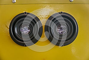 A closeup view of yellow color coin operated binocular