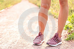 Closeup view of young female legs in sports shoes outdoors. Sport and fitness concept