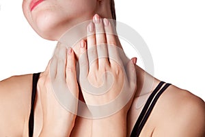 Closeup view of a young woman with pain on neck or thyroid gland.