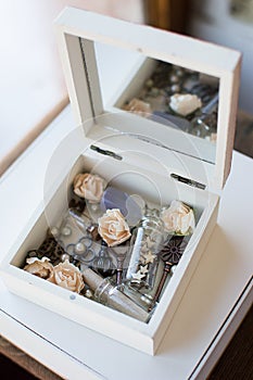 Closeup vintage casket of secrets with mirror, flowers, keys and small glass jars