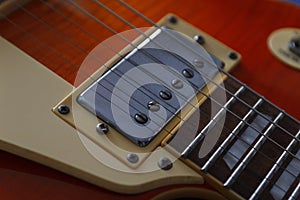 Closeup of vintage electric guitar. Detail, selective focus. Low key.