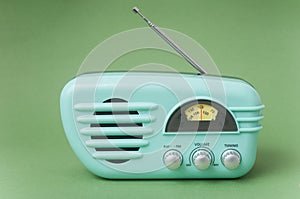 Vintage fifties style radio on green background