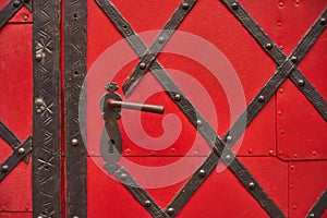 Old riveted metal red painted door