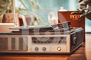 Closeup of vintage record player turntable with record inside old room