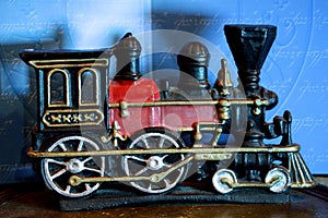 Closeup of a vintage statue of an old train on a shelf under the lights