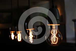 Closeup of vintage style light bulbs hanging from the ceiling