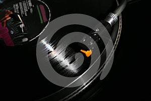 Closeup of vinyl turntable, hi-fi headshell cartridge in action, Retro gramophone playing analog disc with music. place