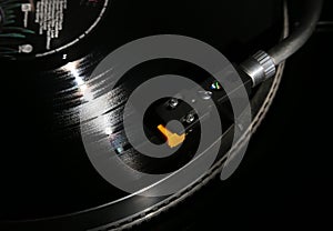 Closeup of vinyl turntable, hi-fi headshell cartridge in action, Retro gramophone playing analog disc with music. place