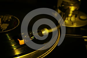 Closeup of vinyl turntable, hi-fi headshell cartridge in action, Retro gramophone playing analog disc with music. place