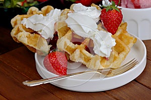 Closeup of waffles with whipped cream and strawberries photo