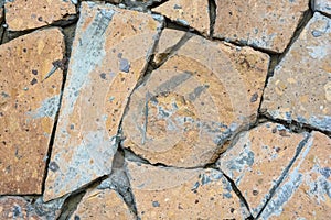 Closeup wall covered in pieces of stone background