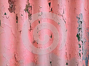 Closeup of the wall with a decorative pink colored plaster vertical lines and stripes