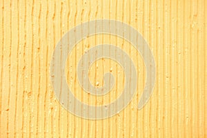 textured yellow background with plaster vertical lines and stripes