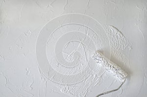 Closeup of wall painting using a roller