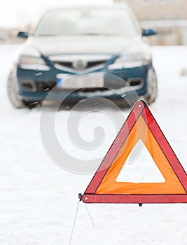 Closeup of warning triangle and car