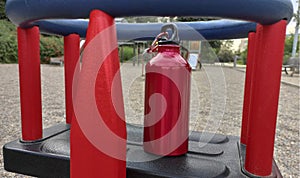 Closeup of a water bottle  on the teeter-totter on the playground