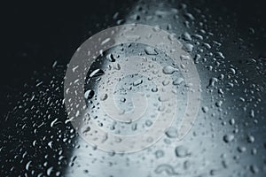 Closeup of water droplets on a dark metal