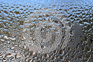 Closeup of water droplets on a window during a cold winter day