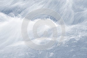 Closeup of water flowing fast over the rock