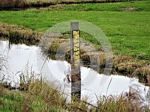 Closeup of a water level indicator gauge at the river