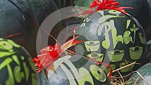 Closeup Watermelons Decorated with Red Bow and Carved Letters