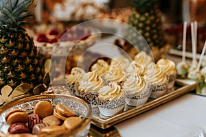 Closeup of a wedding candybar with cakes and fruits