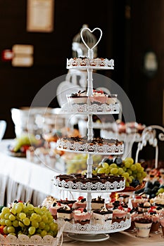 Closeup of a wedding candybar with cakes and fruits