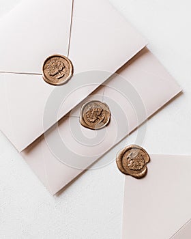 Closeup of wedding envelopes with wax seals on a white background