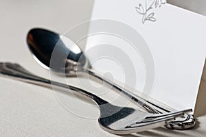 Closeup of wedding place card and cutlery