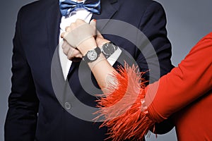 Closeup of well dressed stylish couple wearing wristwatches