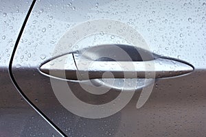 Closeup of a wet car door handle