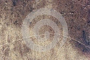 Closeup of wet colorfull sand pattern of a beach