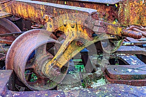 Closeup of a wheel on old train bogie, support and central axle