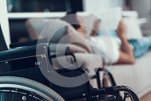 Closeup Wheelchair with Blurred Man on Background