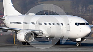 Closeup of the white Boeing 737-800 taxing after landing at Krakow Balice Airport