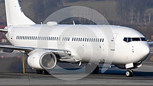 Closeup of the white Boeing 737-800 taxing after landing at Krakow Balice Airport photo