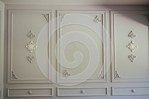 Closeup of white boiserie panels in art deco style