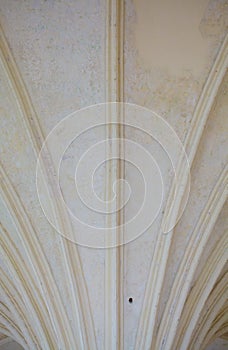 Closeup white ceiling supported by old columns. Architectural part