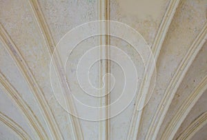 Closeup white ceiling supported by old columns. Architectural part