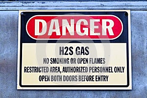 Closeup of a white Danger H2S Gas sign