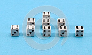 White gamble dice pyramid blue background