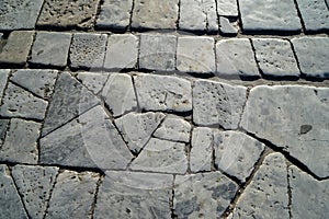 Closeup white and grey color brick marble stone texture outdoor pavement in natural cut pattern background under sunlight