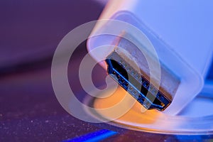 Closeup of white HDMI cable with it`s reflection on blank disc