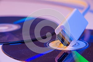 Closeup of white HDMI cable with it`s reflection on blank disc
