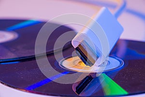 Closeup of white HDMI cable with it`s reflection on blank disc