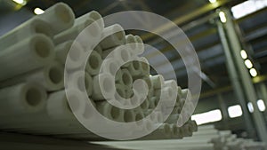 Closeup White Long Polyethylene Pipes in Storehouse