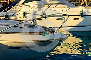 Closeup of white luxury yacht in a sea harbor of Hurghada, Egypt. Marina with tourist boats on Red Sea