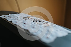 Closeup of a white ornament cloth on TV with a blurry background